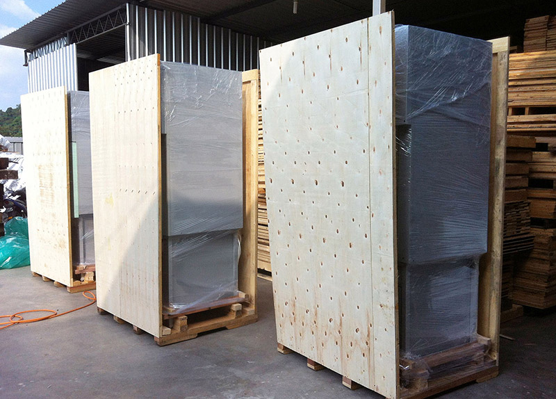 A row of wooden crate lined up in wooden factory.